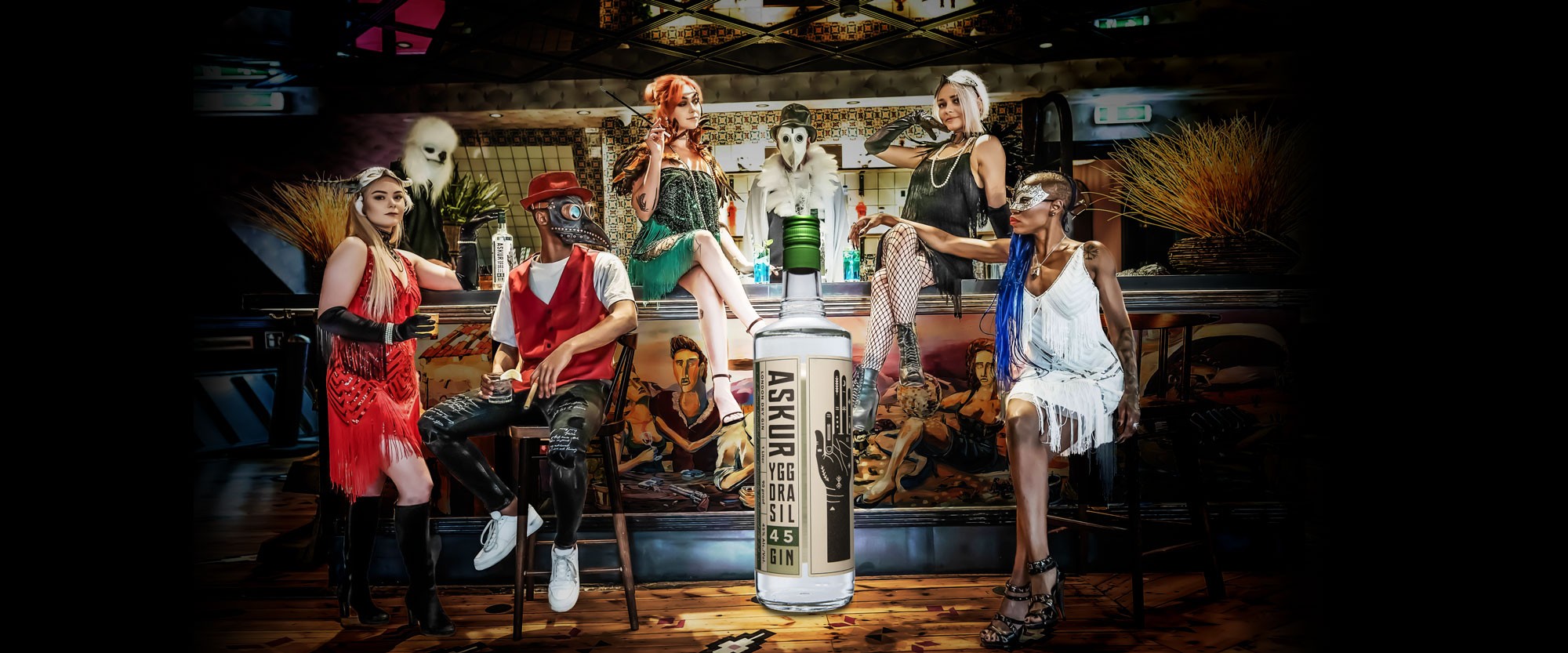 Costumed group posed around a bottle of Askur gin