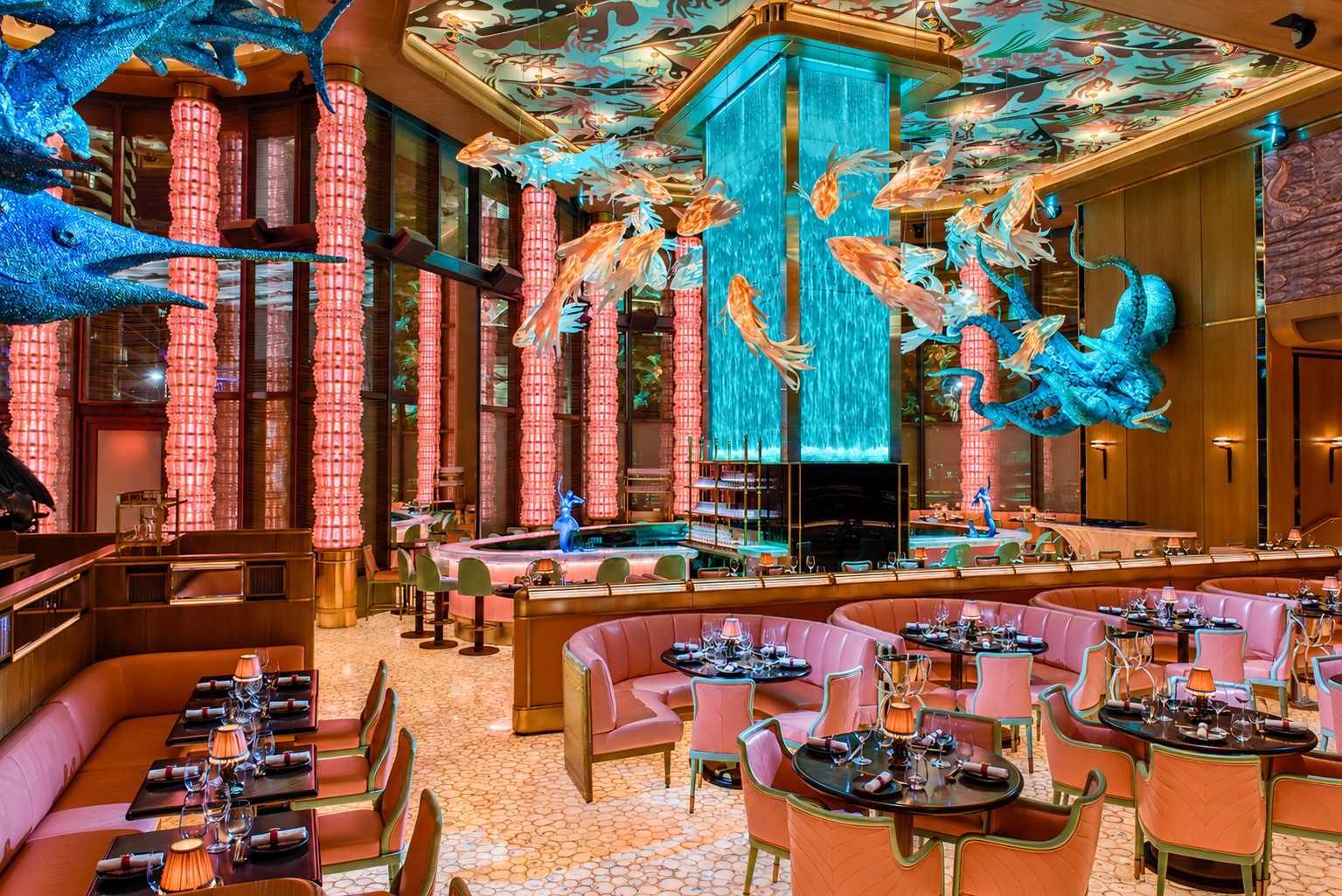 Sexy Fish Miami dining room with pink columns and sculpted fish on the ceiling