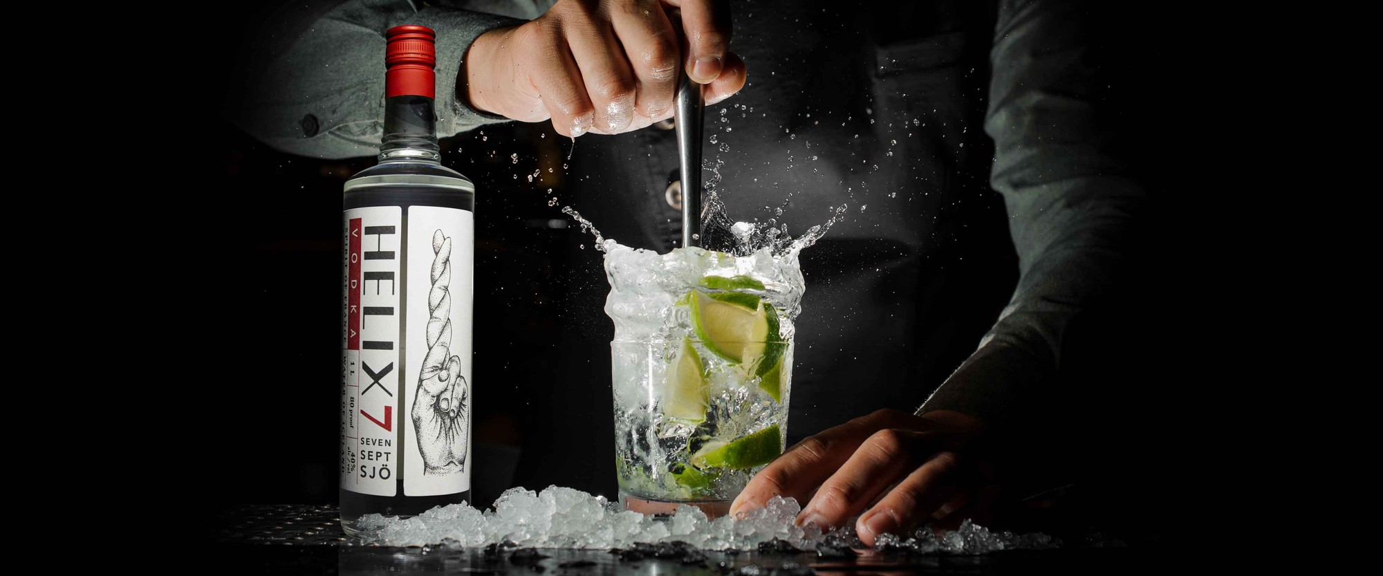 Bartender making a cocktail beside a bottle of HELIX7 Vodka